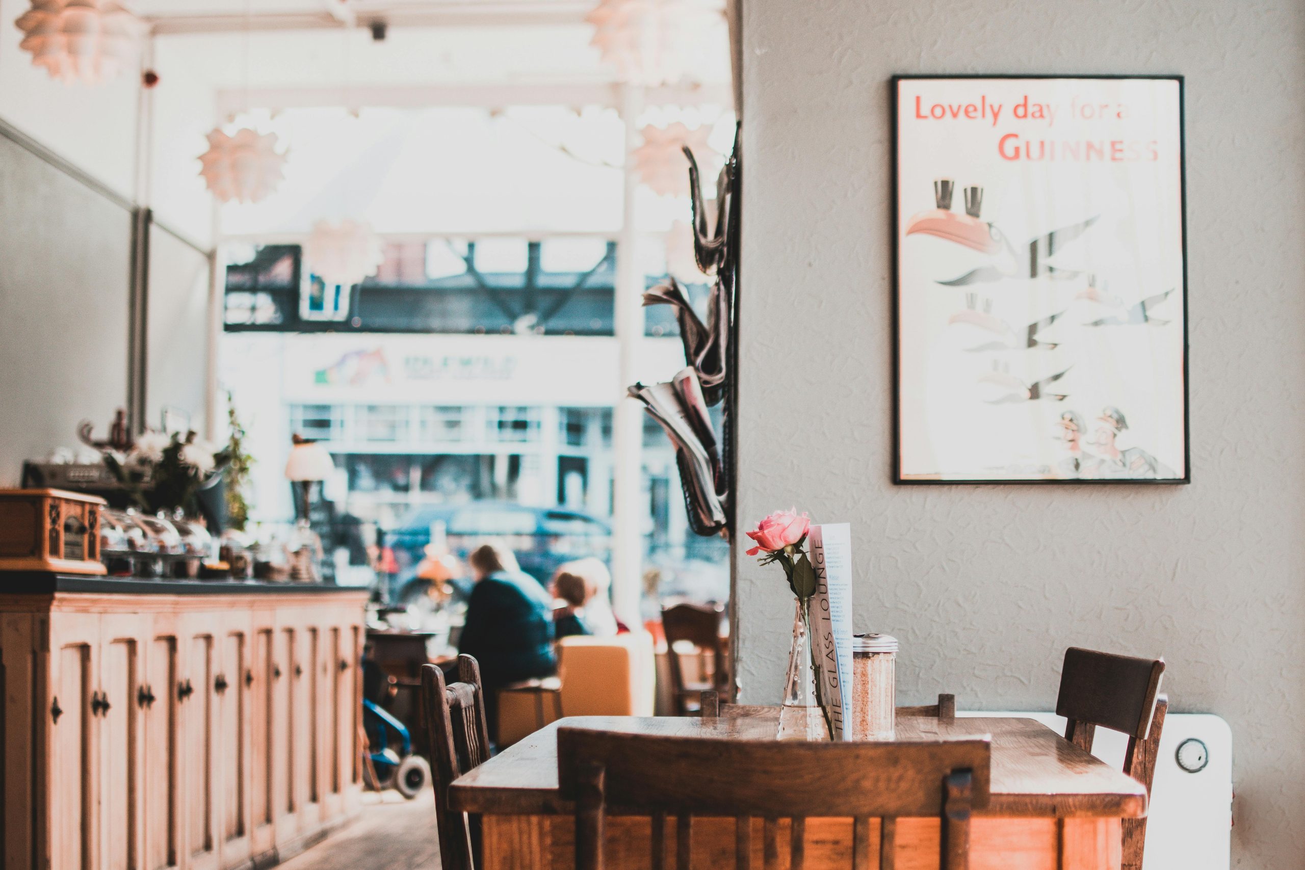A charming café interior showcasing wooden furniture, warm lighting, and cozy atmosphere.